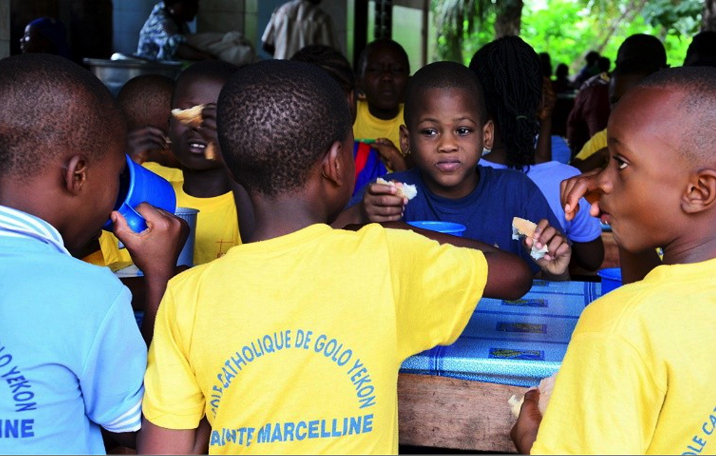 Benin schoolboys having breakfast at theit school in Golo Djigbé